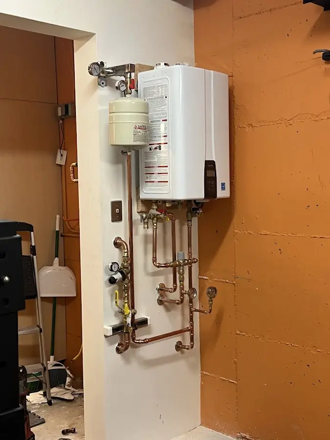 Plumbing technician inspecting water heater connections in South Sarasota